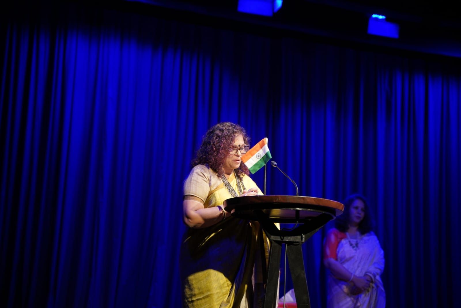 Sarita Nair speaking at a podium