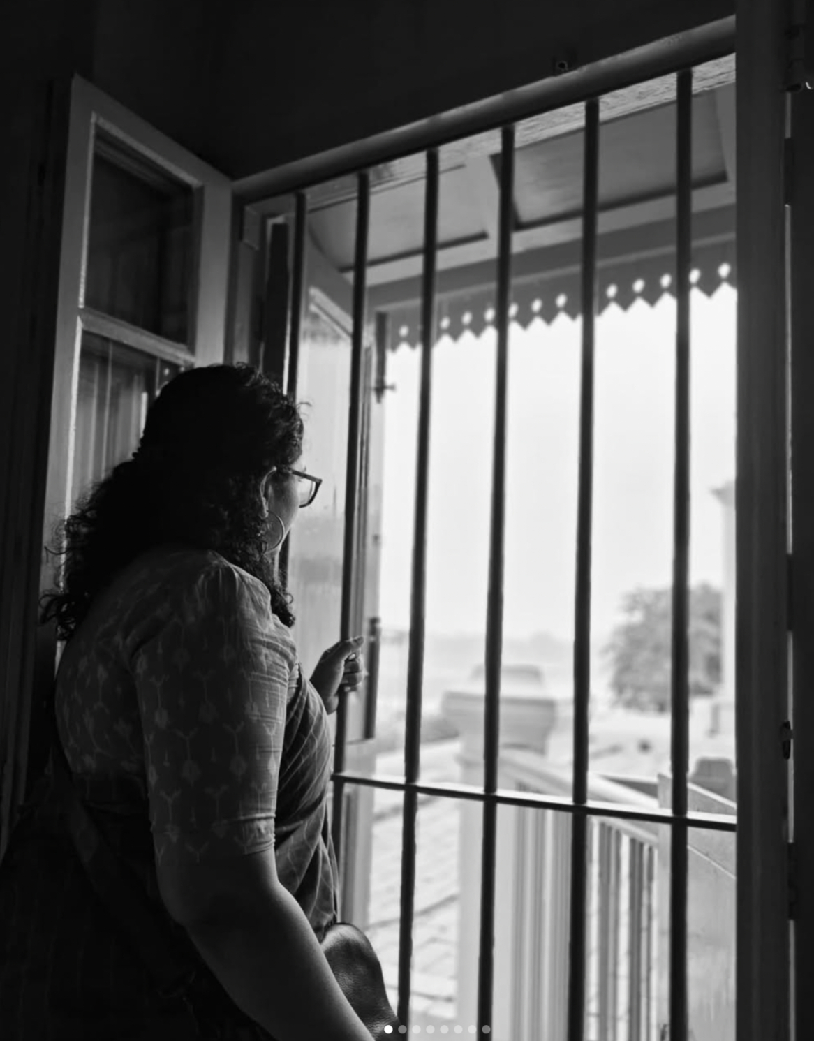 Black and white portrait near a window